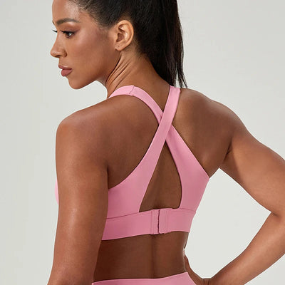 Women's Pink Sports Bra featuring a halter neck and cross back. Twist front detail .