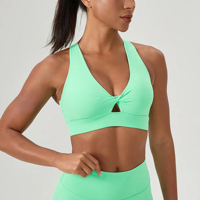 Women's Cross Back Green Sports Bra featuring a halter neck and twist detail to the front. 